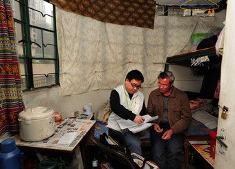 An URA staff member interviewing a tenant affected by the project.